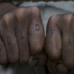 Hold Fast Two fists with the words Hold Fast tattooed on the fingers.
